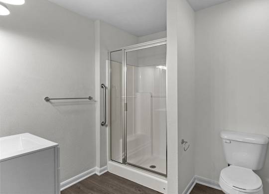 an empty bathroom with a shower and a toilet
