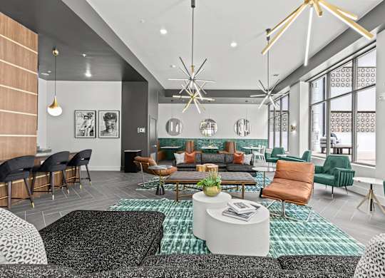 A modern living room with a variety of seating options and a large window.