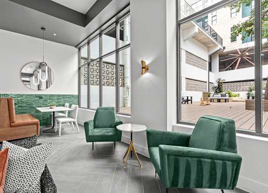 A living room with a green chair and a white table.