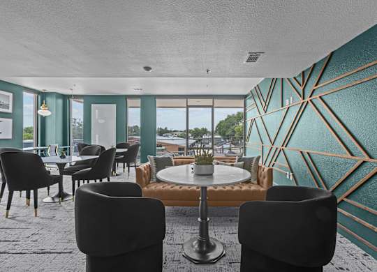 A room with a table surrounded by chairs.