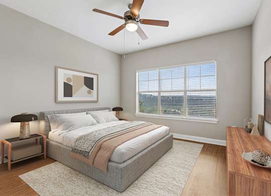 A bedroom with a bed, nightstand, and a ceiling fan.