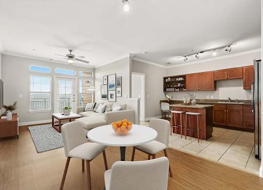 A modern kitchen with a dining table set for four.