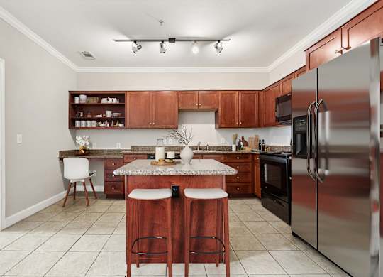 A kitchen with a white countertop and stainless steel appliances.