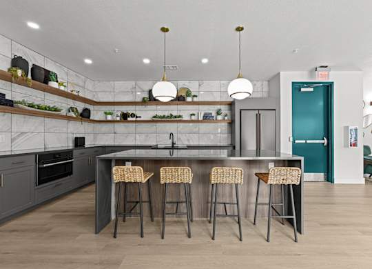 A kitchen with a bar area and stools.