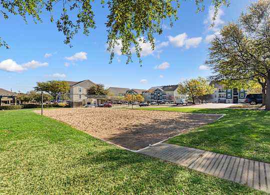 A park with a playground and a walking path.