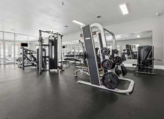 A gym with a variety of equipment including a leg press machine.