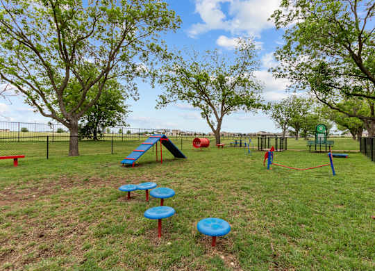 A playground with a slide, swings, and a ball pit.