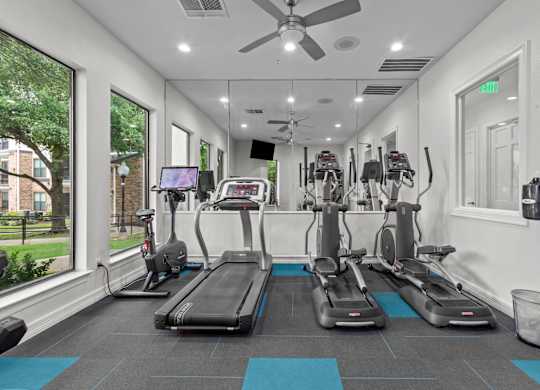 A gym with treadmills and exercise bikes.