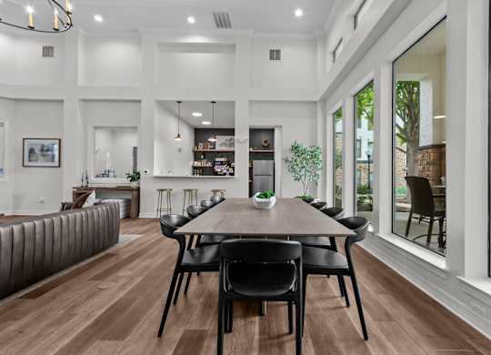 A modern dining room with a wooden table and chairs.