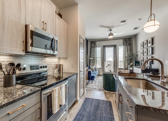 a kitchen with stainless steel appliances and granite counter tops