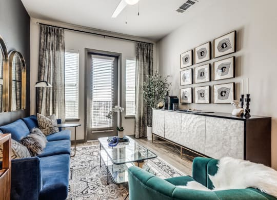 a living room with a blue couch and a glass coffee table