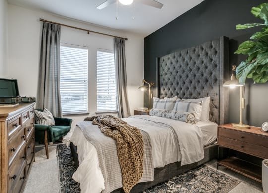 a bedroom with a bed and a dresser and a window