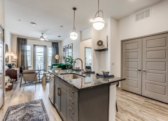 a kitchen with an island and a living room