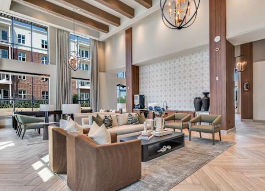 A modern living room with a large sofa set and a chandelier.