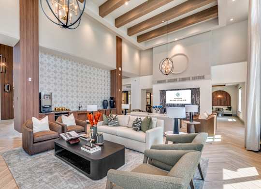 A modern living room with a dark wood floor and furniture.
