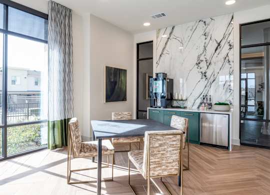 A modern dining room with a marble wall and a table set for two.