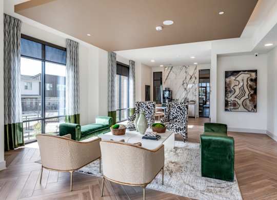 A modern living room with a green chair and a white sofa.