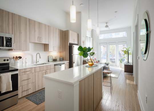 A modern kitchen with wooden cabinets and a white island.