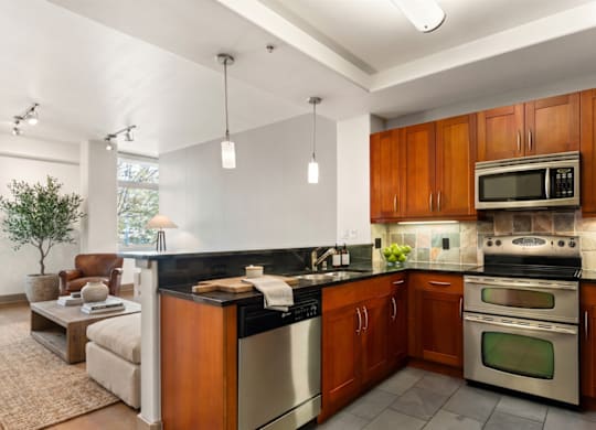 A modern kitchen with wooden cabinets and stainless steel appliances.