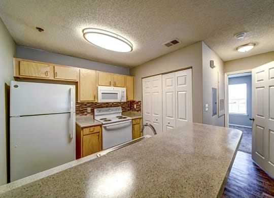 a kitchen with white appliances and a counter top