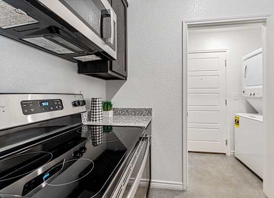 a kitchen with stainless steel appliances and a white door