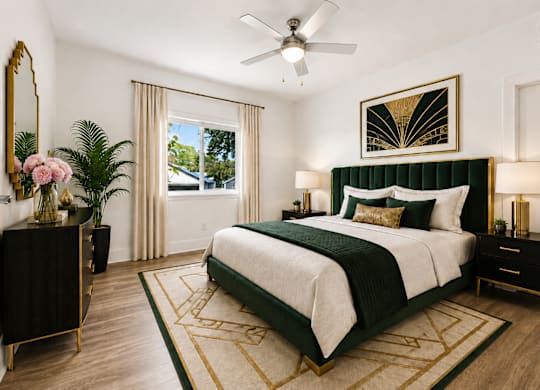 A bedroom with a large bed and a ceiling fan.