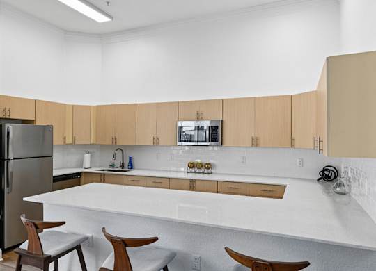 A kitchen with wooden cabinets and a white countertop.