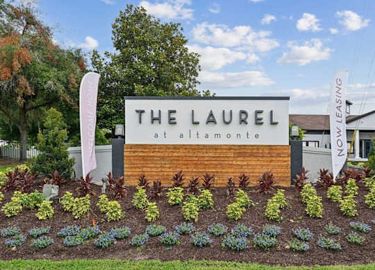 The Laurel at Alta Monroe sign in front of a building.