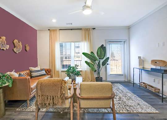 A living room with a brown chair and a brown couch.