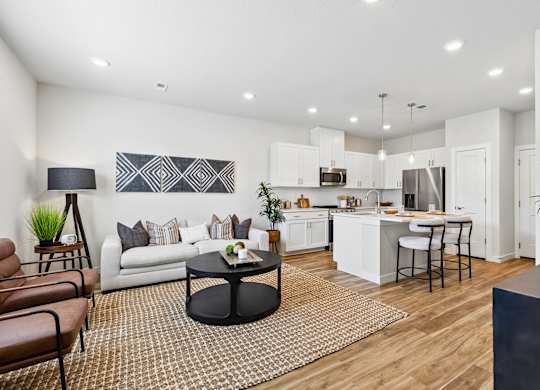 A modern living room with a white couch and a black coffee table.