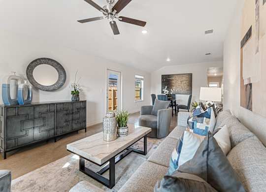 a living room with a ceiling fan and a couch