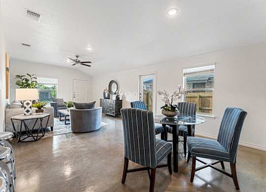an open living room with a dining room table and chairs