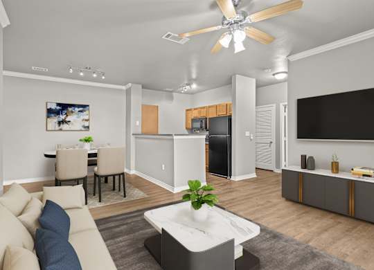 A modern living room with a beige sofa and a white coffee table.