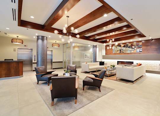 A modern office lobby with a reception desk and comfortable seating areas.
