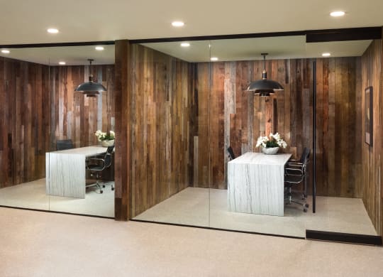 a conference room with wooden walls and a table and chairs