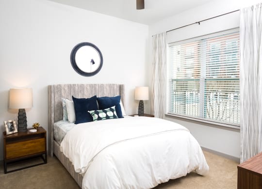 a bedroom with a large bed and a window