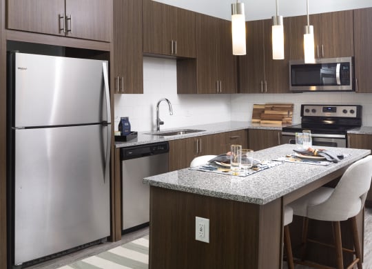 a kitchen with stainless steel appliances and a granite counter top