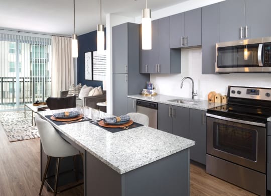 a kitchen and living room with an island and a dining table