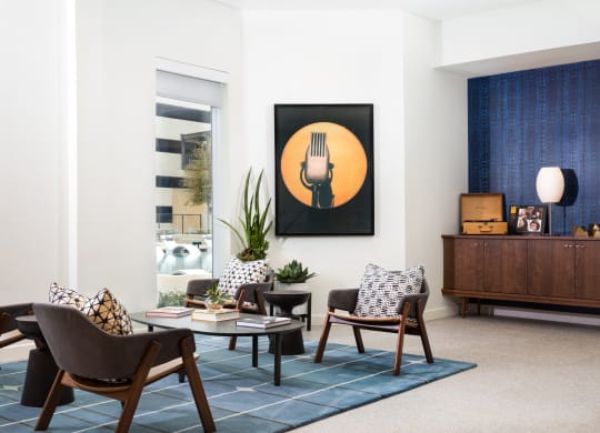 a living room with chairs and a coffee table
