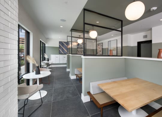 a dining area with a wooden table and chairs and a glass partition
