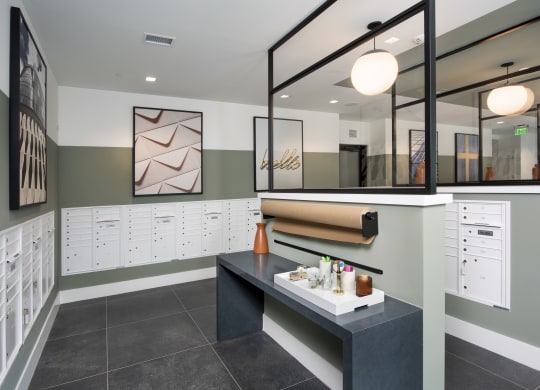 a locker room with a black counter and a row of white lockers