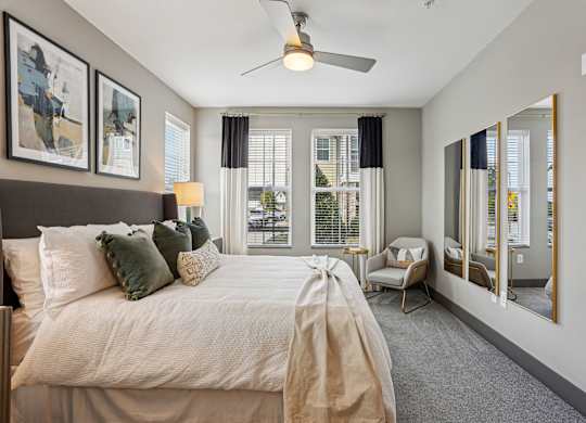 A bedroom with a large bed and a ceiling fan.