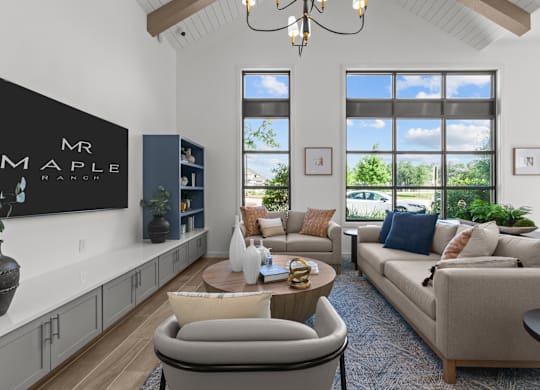 A living room with a couch, chair, and a large window.