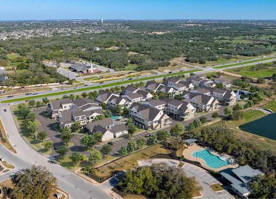 an aerial view of a neighborhood with houses and a swimming pool