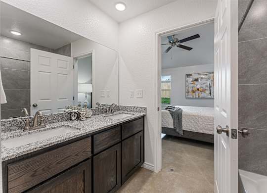 a bathroom with a shower and a sink and a mirror