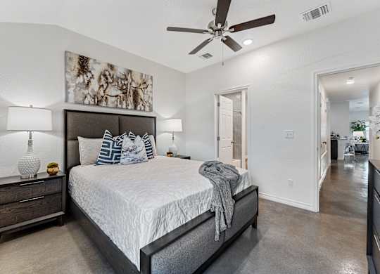 a bedroom with a large bed and a ceiling fan