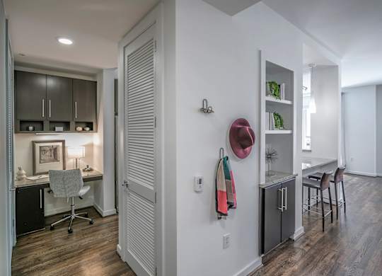A room with a desk and a chair in it.