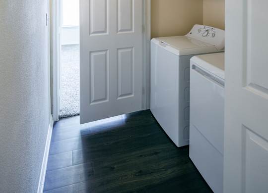 A small laundry room with a washer and dryer.