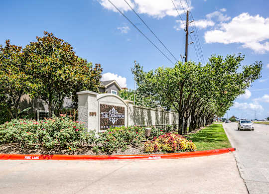 The entrance to The Dominion apartments is surrounded by a well-manicured garden.