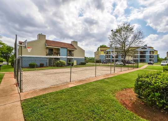 A residential area with houses and a basketball court.